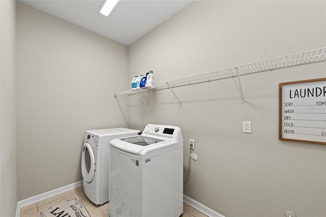 5224 58th Ter E, Bradenton, FL 34203 - laundry room featuring washer and clothes dryer, baseboards, and light tile patterned floors