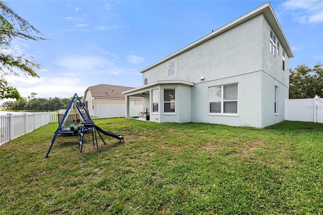 5224 58th Ter E, Bradenton, FL 34203 - back of property featuring stucco siding and a playground