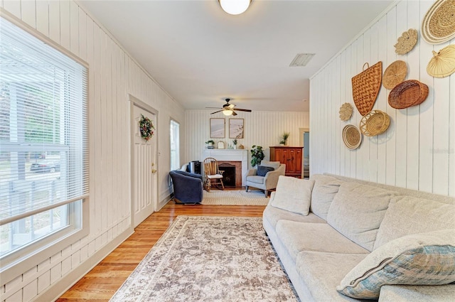 2509 8th Ave W, Bradenton, FL 34205 - living area with light wood-style flooring, a fireplace, and a ceiling fan