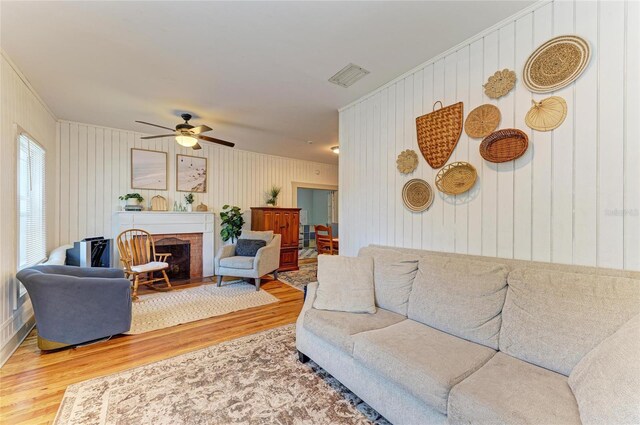 2509 8th Ave W, Bradenton, FL 34205 - living room with wood finished floors, a ceiling fan, ornamental molding, and a fireplace