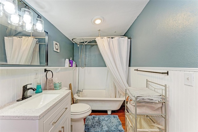 2509 8th Ave W, Bradenton, FL 34205 - bathroom featuring wainscoting, vanity, toilet, wood finished floors, and shower / bath combo