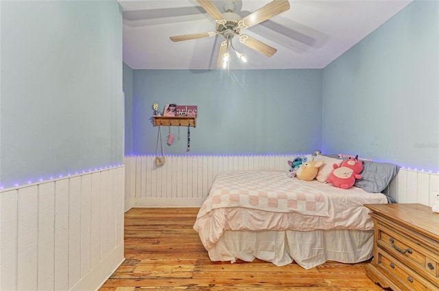 2509 8th Ave W, Bradenton, FL 34205 - bedroom featuring hardwood / wood-style flooring, a wainscoted wall, and ceiling fan