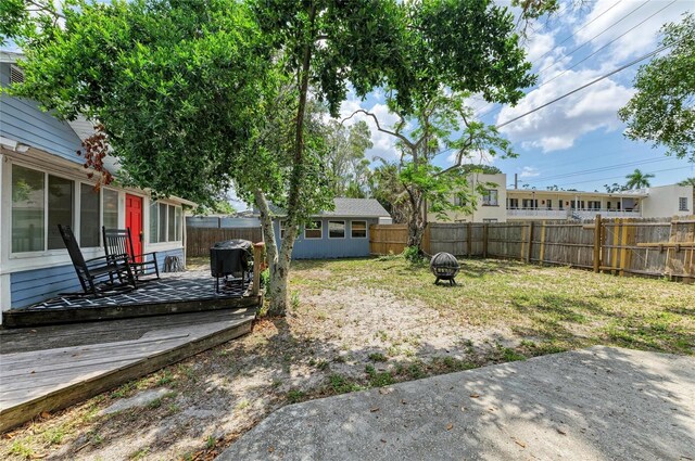 2509 8th Ave W, Bradenton, FL 34205 - fenced backyard with a fire pit and a wooden deck