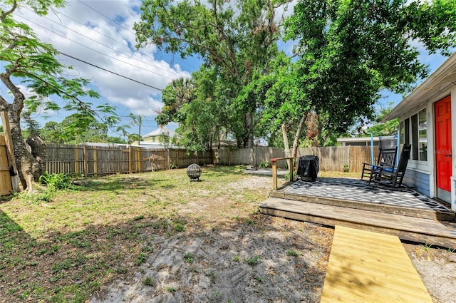 2509 8th Ave W, Bradenton, FL 34205 - fenced backyard featuring a wooden deck and a fire pit