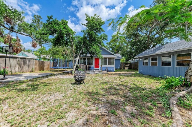 2509 8th Ave W, Bradenton, FL 34205 - back of house with a trampoline and an outdoor fire pit