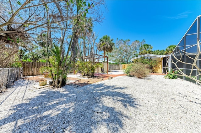 5223 Shadow Lawn Dr, Sarasota, FL 34242 - fenced backyard with glass enclosure and a patio
