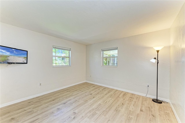 5223 Shadow Lawn Dr, Sarasota, FL 34242 - spare room featuring light wood-style flooring and baseboards