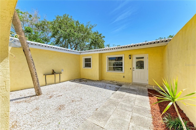 5223 Shadow Lawn Dr, Sarasota, FL 34242 - entrance to property with stucco siding and a patio