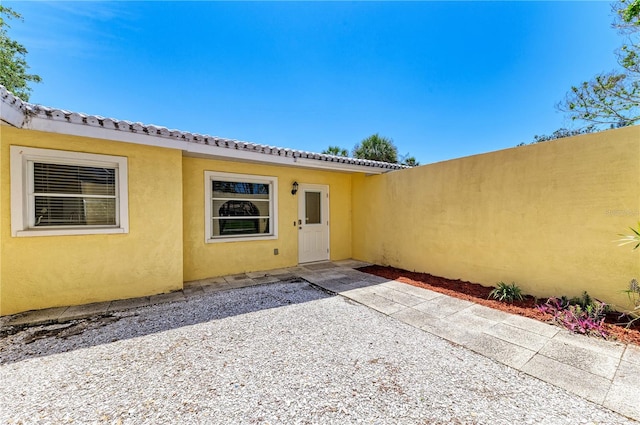 5223 Shadow Lawn Dr, Sarasota, FL 34242 - property entrance with stucco siding and a patio area