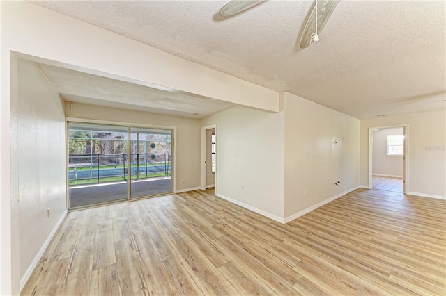 5223 Shadow Lawn Dr, Sarasota, FL 34242 - unfurnished room featuring light wood finished floors, a textured ceiling, and baseboards