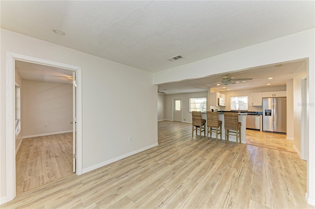 5223 Shadow Lawn Dr, Sarasota, FL 34242 - living room with light wood finished floors, a ceiling fan, and baseboards