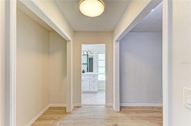 5223 Shadow Lawn Dr, Sarasota, FL 34242 - corridor featuring light wood finished floors and baseboards