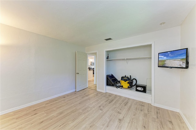 5223 Shadow Lawn Dr, Sarasota, FL 34242 - unfurnished bedroom with light wood-style flooring, baseboards, and a closet