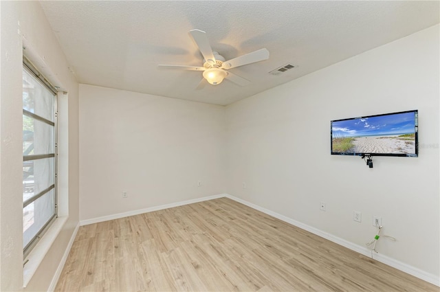 5223 Shadow Lawn Dr, Sarasota, FL 34242 - empty room with light wood finished floors, plenty of natural light, ceiling fan, and baseboards