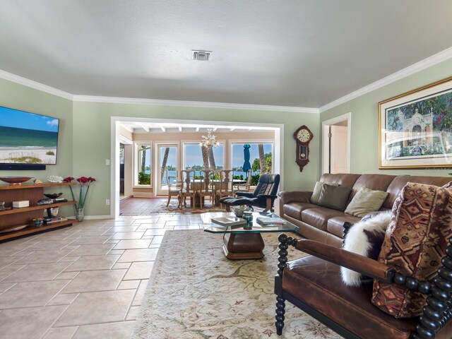 7614 Peninsular Dr, Sarasota, FL 34231 - living area with ornamental molding, baseboards, and stone tile floors