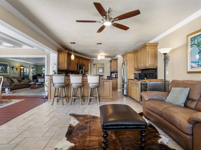 7614 Peninsular Dr, Sarasota, FL 34231 - living area with ceiling fan, a textured ceiling, beverage cooler, and ornamental molding