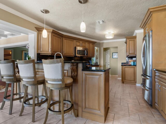7614 Peninsular Dr, Sarasota, FL 34231 - kitchen with appliances with stainless steel finishes, dark countertops, a peninsula, a breakfast bar area, and pendant lighting