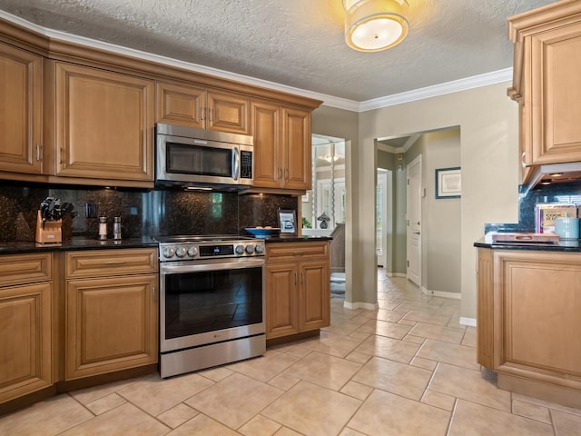 7614 Peninsular Dr, Sarasota, FL 34231 - kitchen featuring appliances with stainless steel finishes, ornamental molding, decorative backsplash, a textured ceiling, and light tile patterned flooring