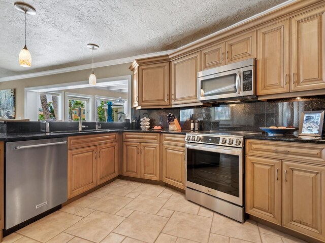 7614 Peninsular Dr, Sarasota, FL 34231 - kitchen featuring stainless steel appliances, crown molding, decorative backsplash, a sink, and hanging light fixtures