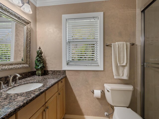 7614 Peninsular Dr, Sarasota, FL 34231 - full bathroom with vanity, healthy amount of natural light, toilet, tiled shower, and ornamental molding