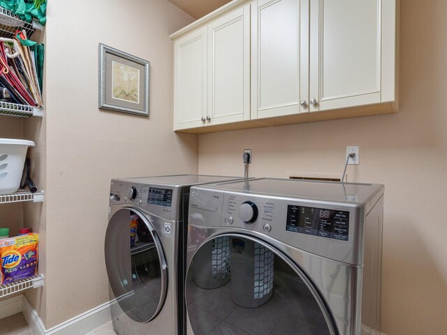 7614 Peninsular Dr, Sarasota, FL 34231 - laundry room with independent washer and dryer, cabinet space, and baseboards
