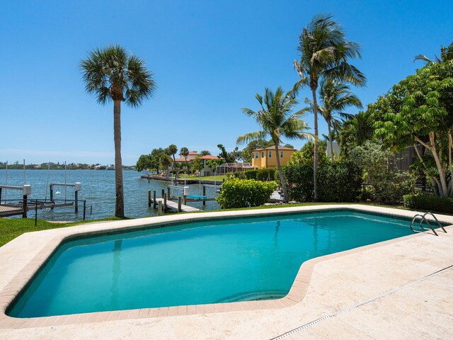 7614 Peninsular Dr, Sarasota, FL 34231 - outdoor pool with a water view, a dock, and boat lift
