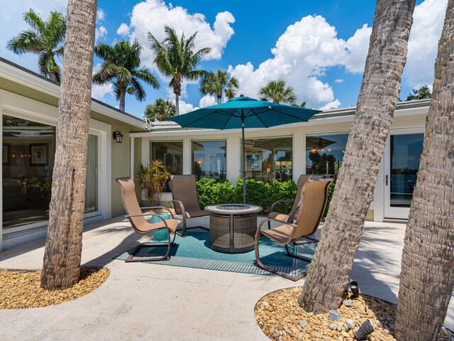 7614 Peninsular Dr, Sarasota, FL 34231 - view of patio / terrace with an outdoor fire pit
