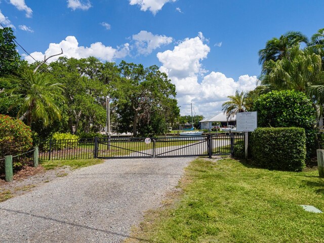 7614 Peninsular Dr, Sarasota, FL 34231 - view of road featuring a gate and a gated entry