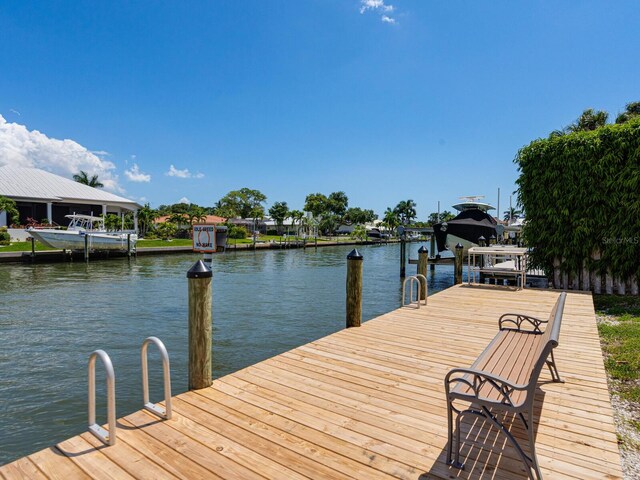 7614 Peninsular Dr, Sarasota, FL 34231 - dock area with a water view and boat lift