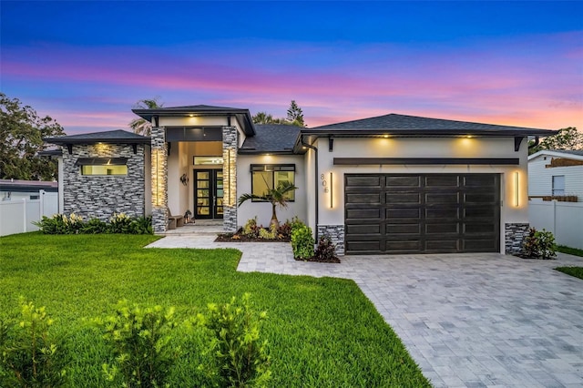 805 Padua Ct, Nokomis, FL 34275 - prairie-style house featuring stone siding, a garage, stucco siding, decorative driveway, and french doors