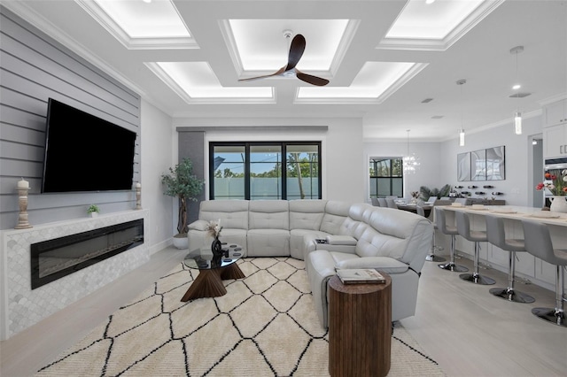 805 Padua Ct, Nokomis, FL 34275 - living area with a ceiling fan, a glass covered fireplace, and crown molding