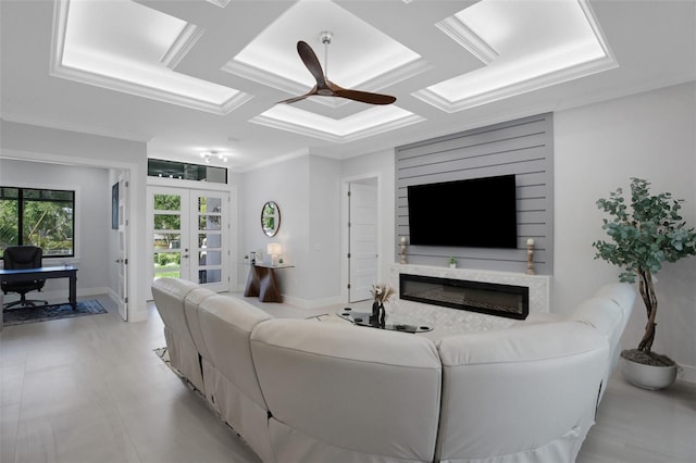 805 Padua Ct, Nokomis, FL 34275 - living room featuring ceiling fan, french doors, a glass covered fireplace, coffered ceiling, and baseboards