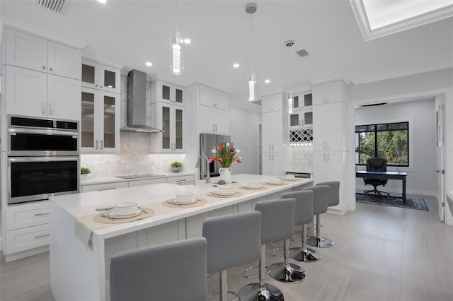 805 Padua Ct, Nokomis, FL 34275 - kitchen with wall chimney exhaust hood, appliances with stainless steel finishes, backsplash, a sink, and light countertops