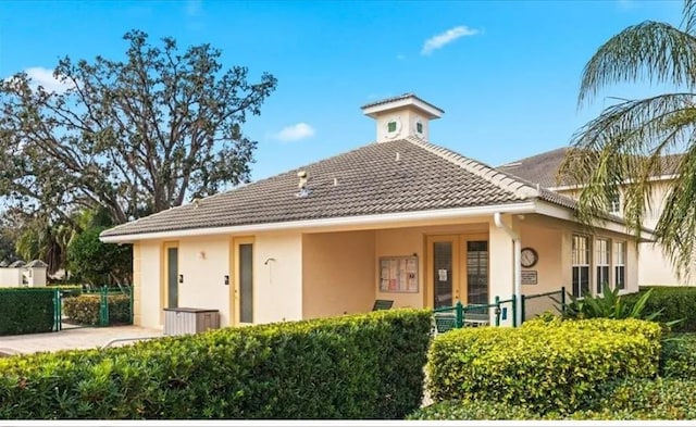 600 Mirabella Cir Unit 201, Venice, FL 34292 - rear view of property featuring stucco siding and a tiled roof