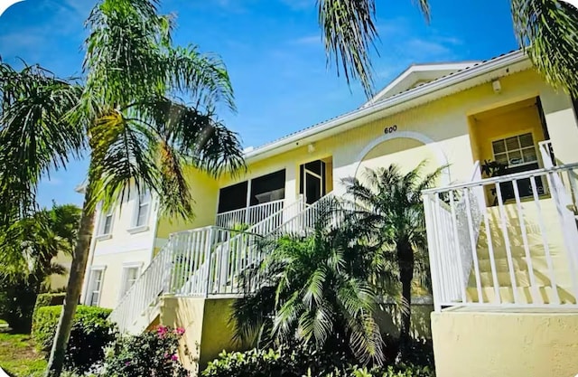 600 Mirabella Cir Unit 201, Venice, FL 34292 - view of side of property with stairway and stucco siding