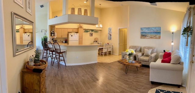 600 Mirabella Cir Unit 201, Venice, FL 34292 - living room featuring high vaulted ceiling, wood finished floors, and baseboards