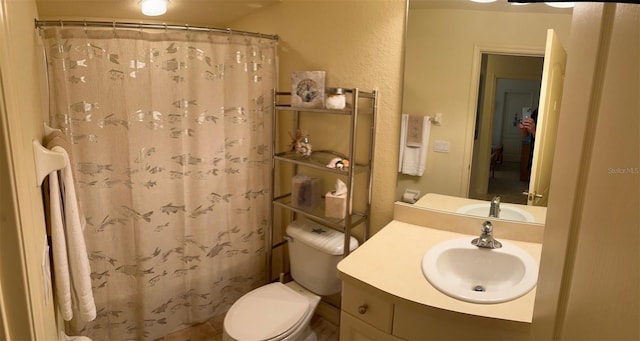 600 Mirabella Cir Unit 201, Venice, FL 34292 - bathroom featuring toilet, vanity, a textured wall, and a shower with shower curtain