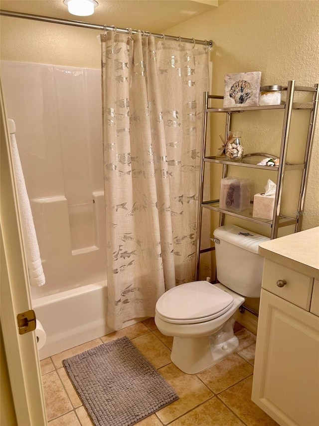 600 Mirabella Cir Unit 201, Venice, FL 34292 - bathroom featuring a textured wall, toilet, tile patterned floors, shower / bath combination with curtain, and vanity