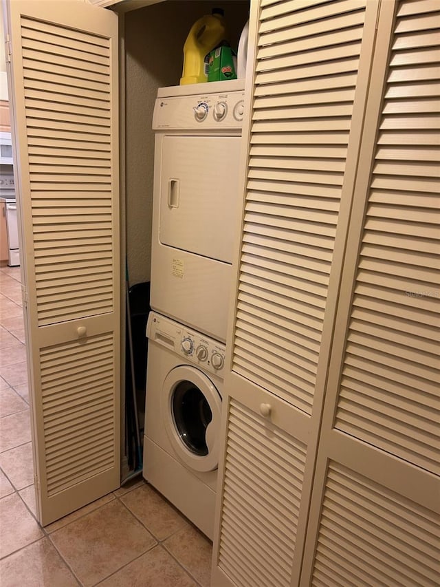 600 Mirabella Cir Unit 201, Venice, FL 34292 - laundry area featuring estacked washer and dryer and light tile patterned floors