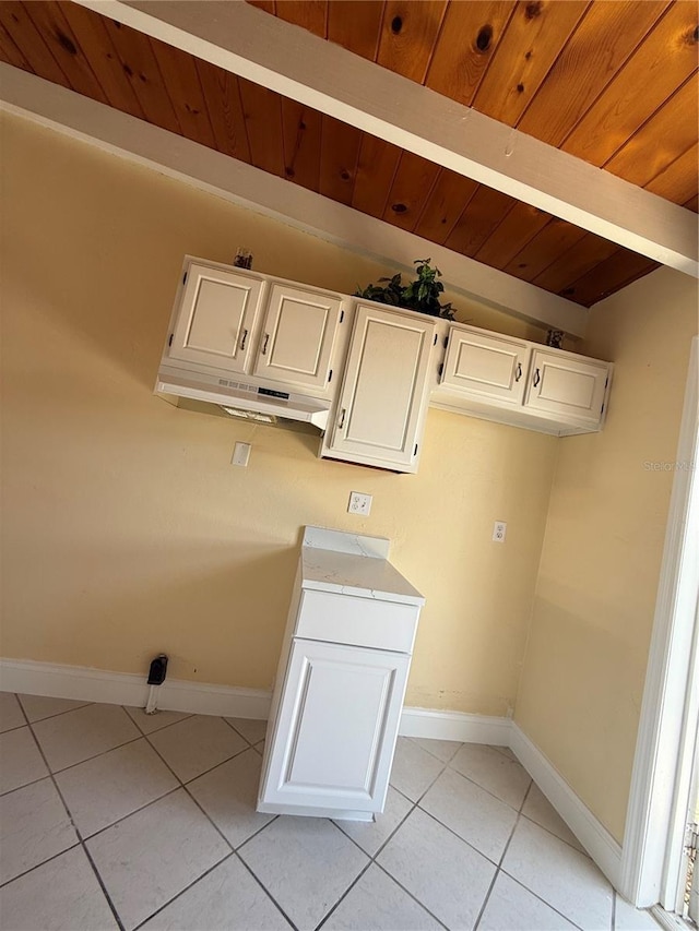 6006 Midnight Pass Rd Unit 48, Sarasota, FL 34242 - laundry room featuring light tile patterned floors, baseboards, and wooden ceiling