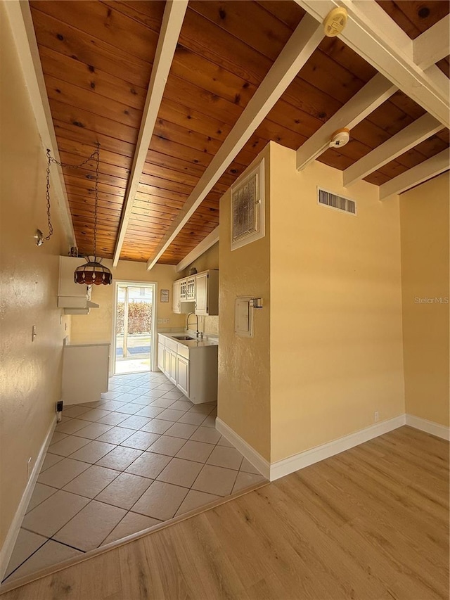 6006 Midnight Pass Rd Unit 48, Sarasota, FL 34242 - hallway with wooden ceiling, a sink, baseboards, and light wood-style flooring