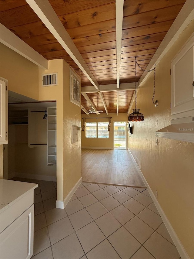 6006 Midnight Pass Rd Unit 48, Sarasota, FL 34242 - hall featuring wood ceiling with exposed beams, light tile patterned floors, and baseboards