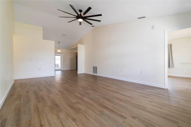 2477 Wood Oak Dr, Sarasota, FL 34232 - unfurnished living room featuring a ceiling fan, wood finished floors, baseboards, and high vaulted ceiling