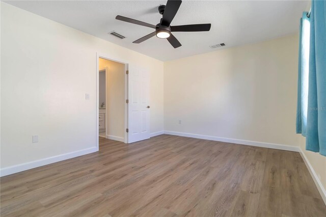 2477 Wood Oak Dr, Sarasota, FL 34232 - spare room with a ceiling fan, wood finished floors, and baseboards