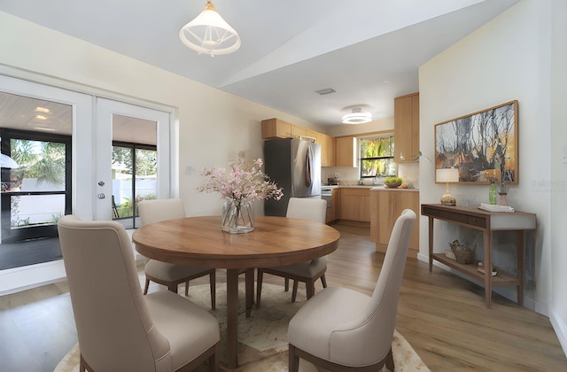 2477 Wood Oak Dr, Sarasota, FL 34232 - dining area featuring lofted ceiling and light wood finished floors