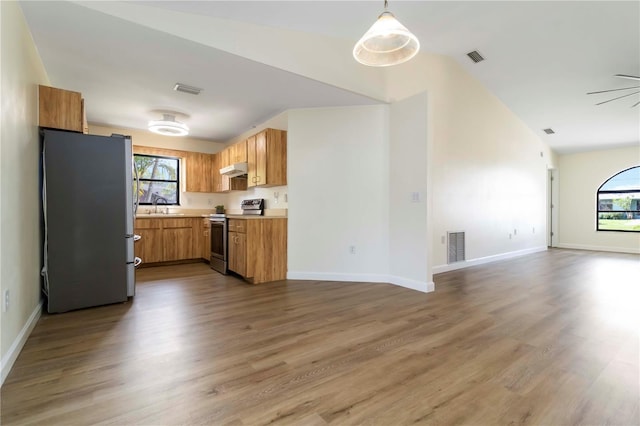 2477 Wood Oak Dr, Sarasota, FL 34232 - kitchen featuring appliances with stainless steel finishes, a sink, open floor plan, under cabinet range hood, and wood finished floors