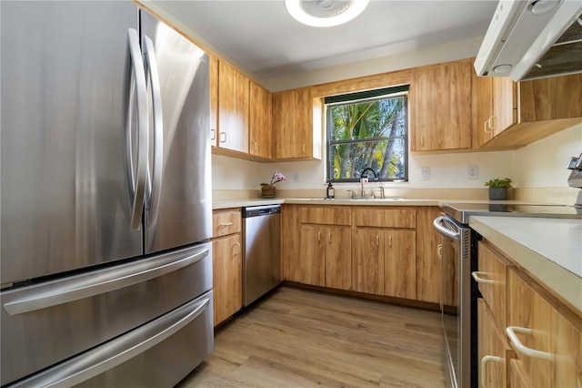 2477 Wood Oak Dr, Sarasota, FL 34232 - kitchen featuring stainless steel appliances, ventilation hood, light countertops, and light wood finished floors