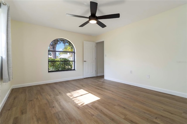 2477 Wood Oak Dr, Sarasota, FL 34232 - unfurnished room featuring wood finished floors, baseboards, and ceiling fan