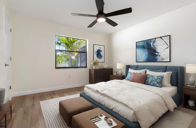 2477 Wood Oak Dr, Sarasota, FL 34232 - bedroom with light wood-type flooring, baseboards, and a ceiling fan