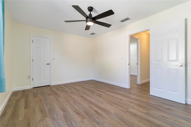 2477 Wood Oak Dr, Sarasota, FL 34232 - spare room featuring wood finished floors, ceiling fan, and baseboards